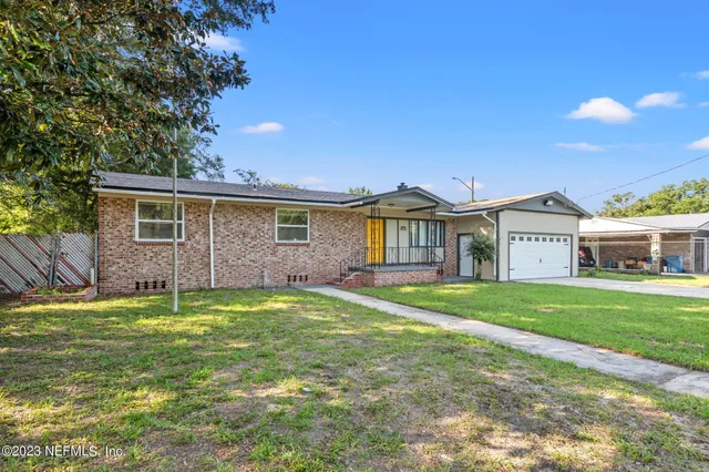 a view of a house with a backyard