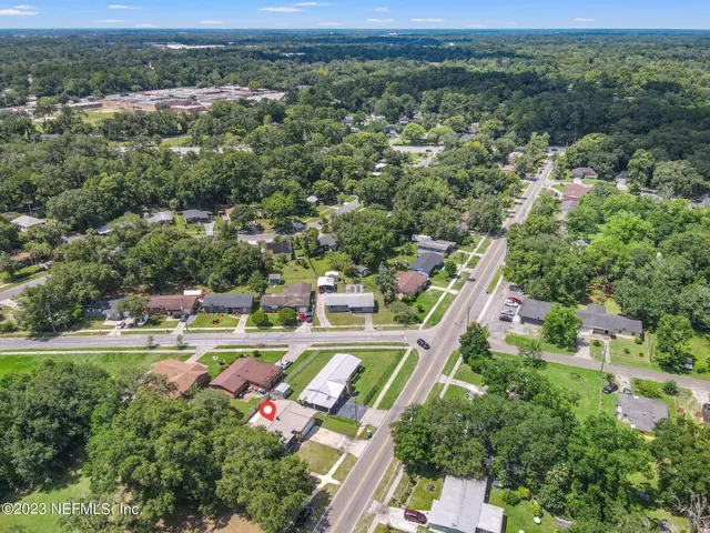 an aerial view of residential houses with outdoor space and river