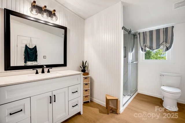 a bathroom with a sink toilet and shower