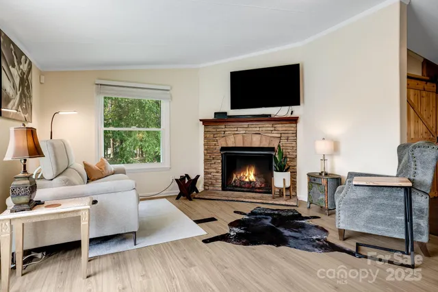 a kitchen with stainless steel appliances a stove a sink dishwasher a refrigerator with a dining table and chairs