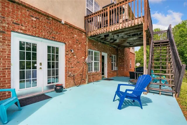 a view of a house with a patio and wooden deck