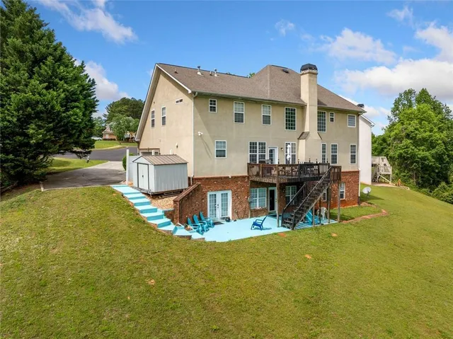 a view of a house with swimming pool and sitting area