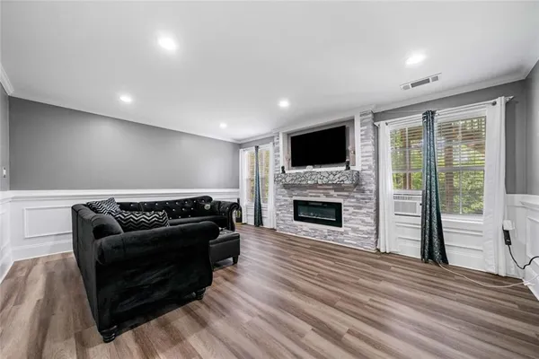 a living room with furniture a fireplace and a flat screen tv