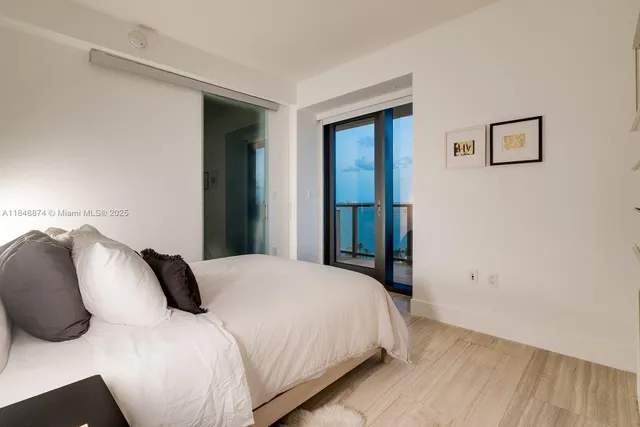 a bedroom with a bed and a painting on the wall