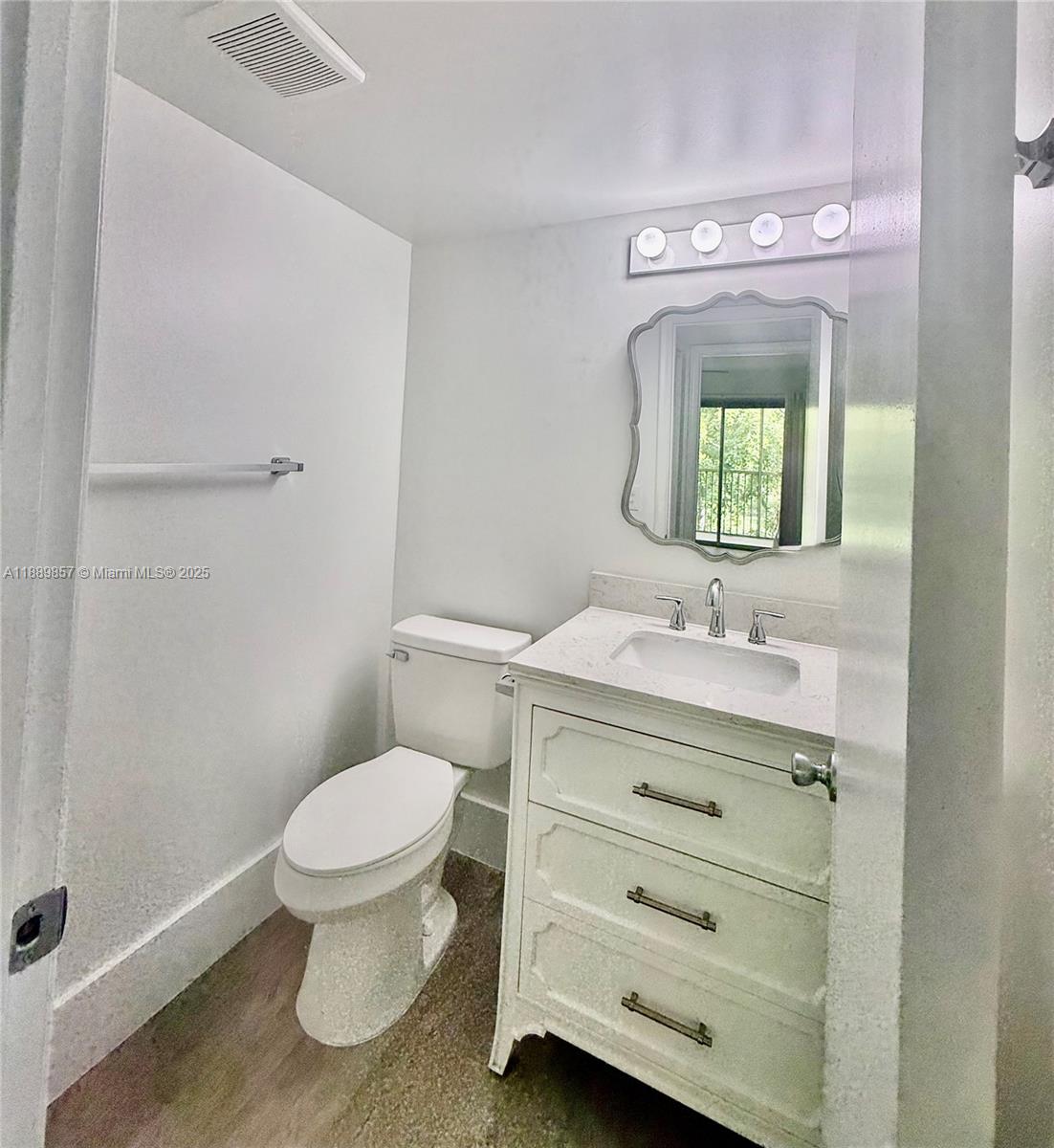 150 Southwest 134th Way, Unit 305R Pembroke Pines, FL 33027 - Photo 14 of 19 a bathroom with a sink a toilet and mirror
