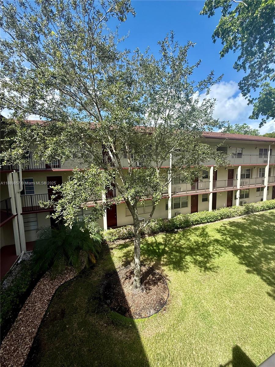 150 Southwest 134th Way, Unit 305R Pembroke Pines, FL 33027 - Photo 18 of 19 a view of a house with backyard garden and sitting area