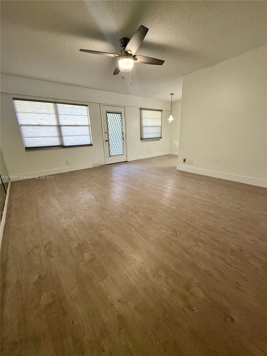 150 Southwest 134th Way, Unit 305R Pembroke Pines, FL 33027 - Photo 19 of 19 an empty room with windows and ceiling fan