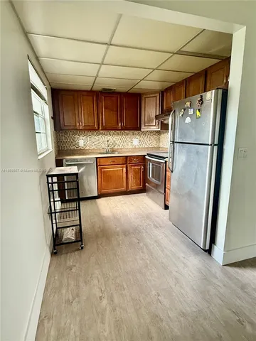 a kitchen with a refrigerator and a sink
