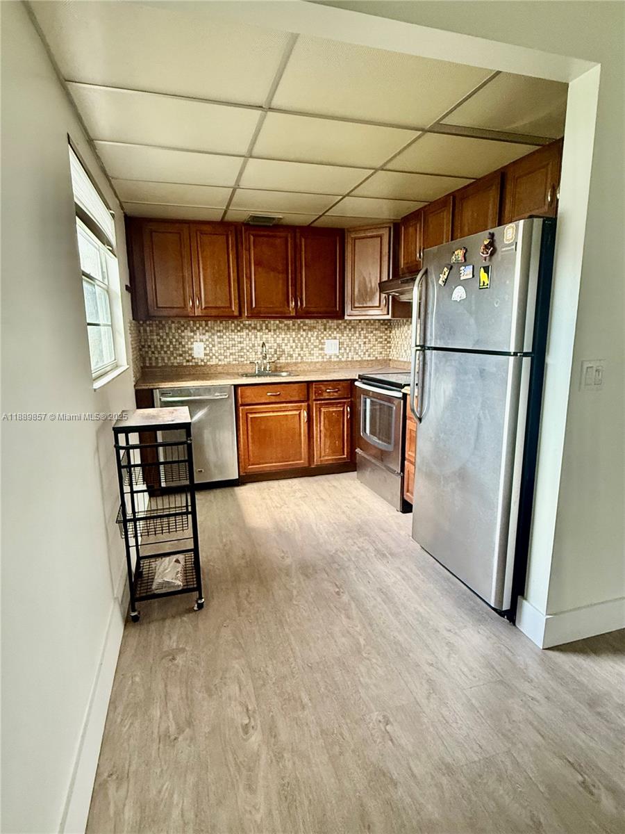 150 Southwest 134th Way, Unit 305R Pembroke Pines, FL 33027 - Photo 3 of 19 a kitchen with a refrigerator and a sink