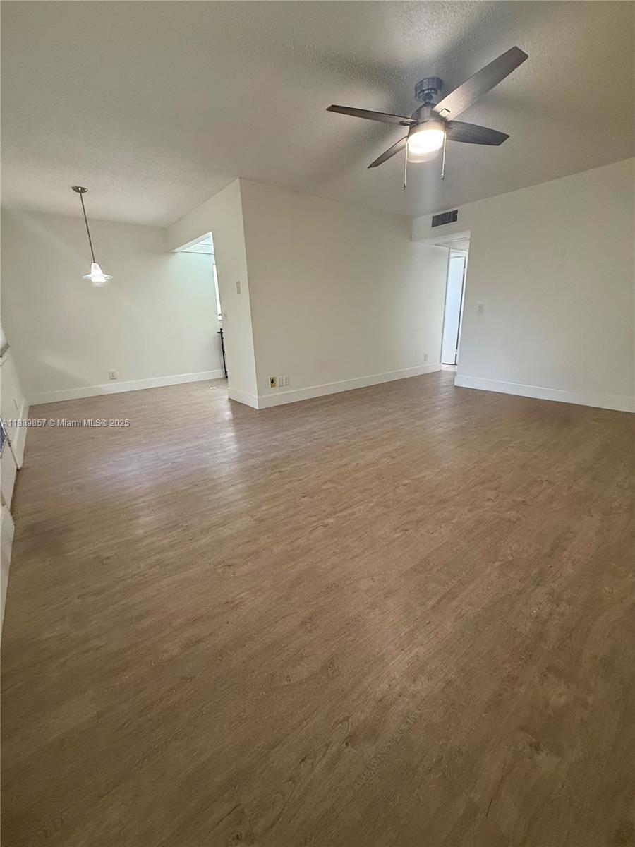 150 Southwest 134th Way, Unit 305R Pembroke Pines, FL 33027 - Photo 5 of 19 an empty room with a ceiling fan and a window