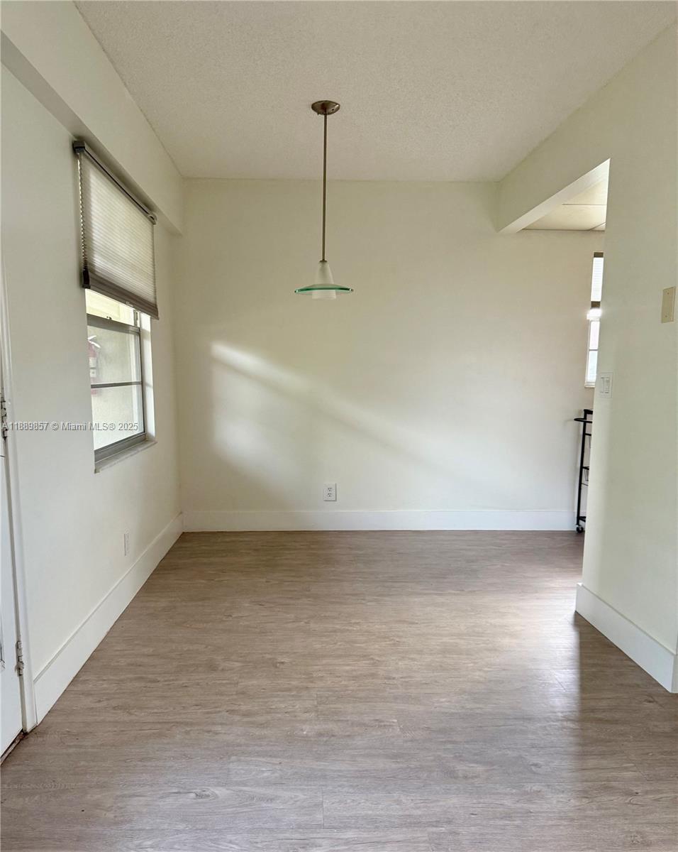 150 Southwest 134th Way, Unit 305R Pembroke Pines, FL 33027 - Photo 6 of 19 wooden floor in an empty room with a window