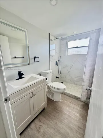 a view of bathroom with a sink toilet and shower