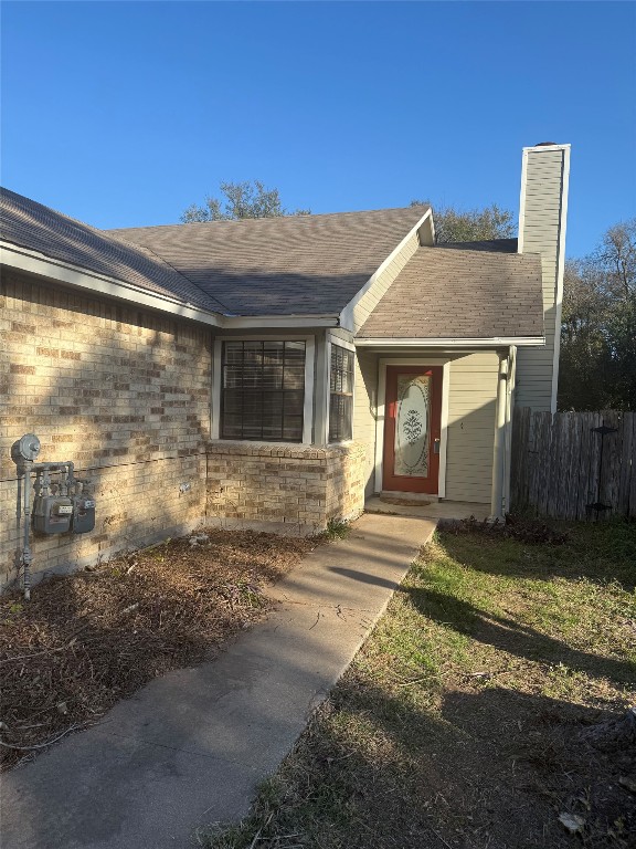 2504 Howellwood Way, Unit B Austin, TX 78748 - Photo 1 of 20 Property entrance featuring brick siding, roof with shingles, and a chimney