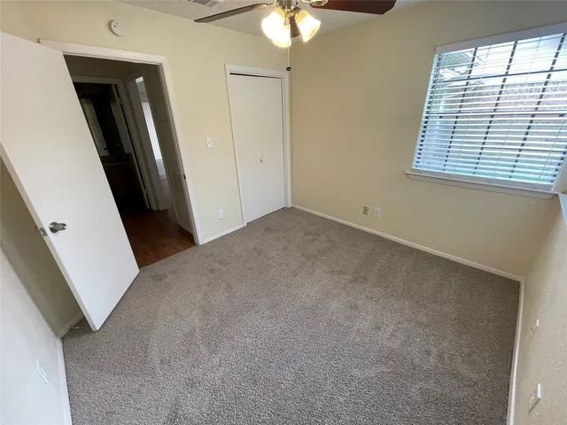 a view of a big room with closet and wooden door