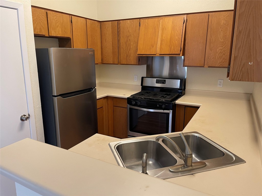2504 Howellwood Way, Unit B Austin, TX 78748 - Photo 2 of 20 a kitchen with a refrigerator sink and cabinets