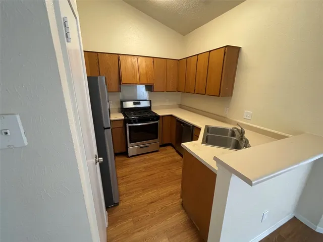 a view of a kitchen from an empty room