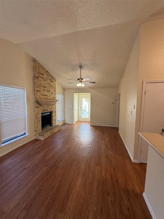 2504 Howellwood Way, Unit B Austin, TX 78748 - Photo 6 of 20 an empty room with wooden floor fireplace and windows