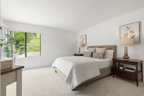 a bedroom with a bed and a night stand