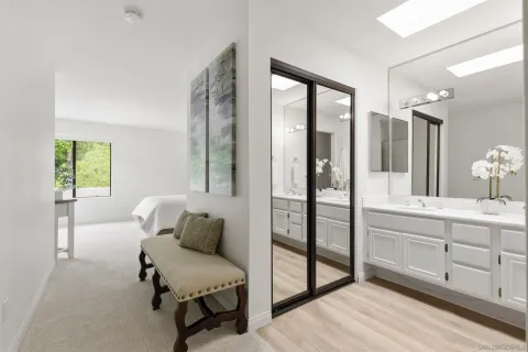 a spacious bathroom with a double vanity sink and a mirror