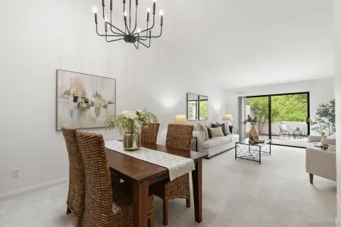 a living room with furniture a chandelier and a large window