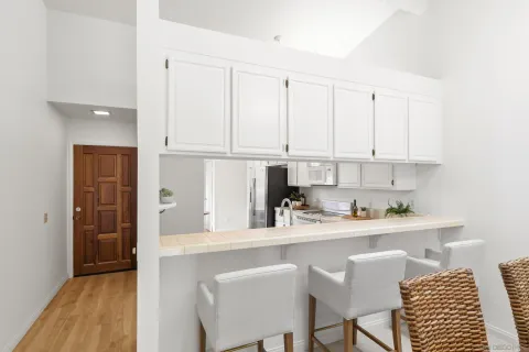 a kitchen with stainless steel appliances granite countertop a sink stove and cabinets