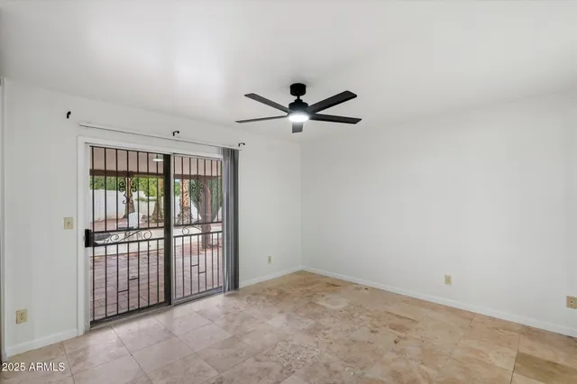 an empty room with windows and closet