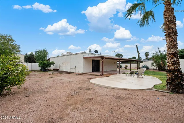 a white house with palm tree in front of it