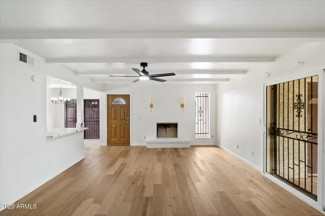 wooden floor in an empty room with a window