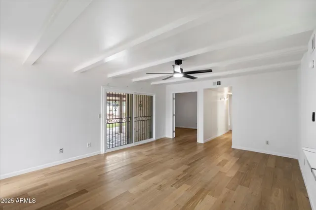 wooden floor in an empty room with a window