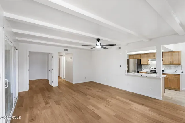a view of a kitchen with a sink and a refrigerator