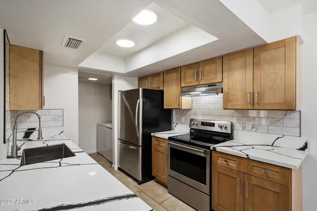a kitchen with a sink stove and refrigerator
