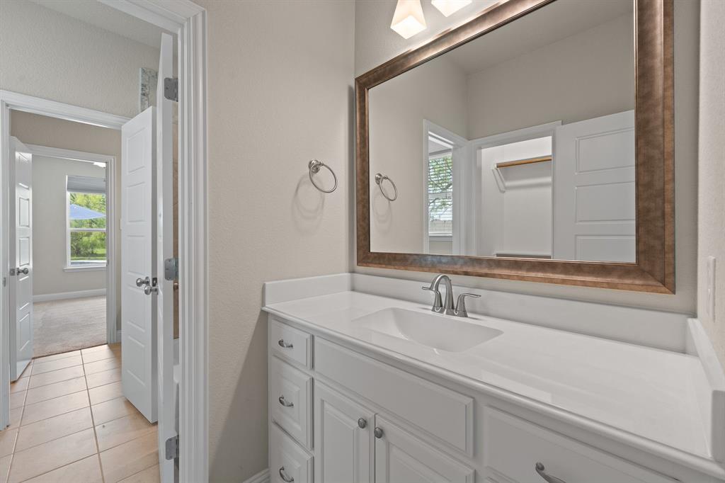 1001 Resolute Road Millsap, TX 76066 - Photo 25 of 40 a bathroom with a sink and a mirror