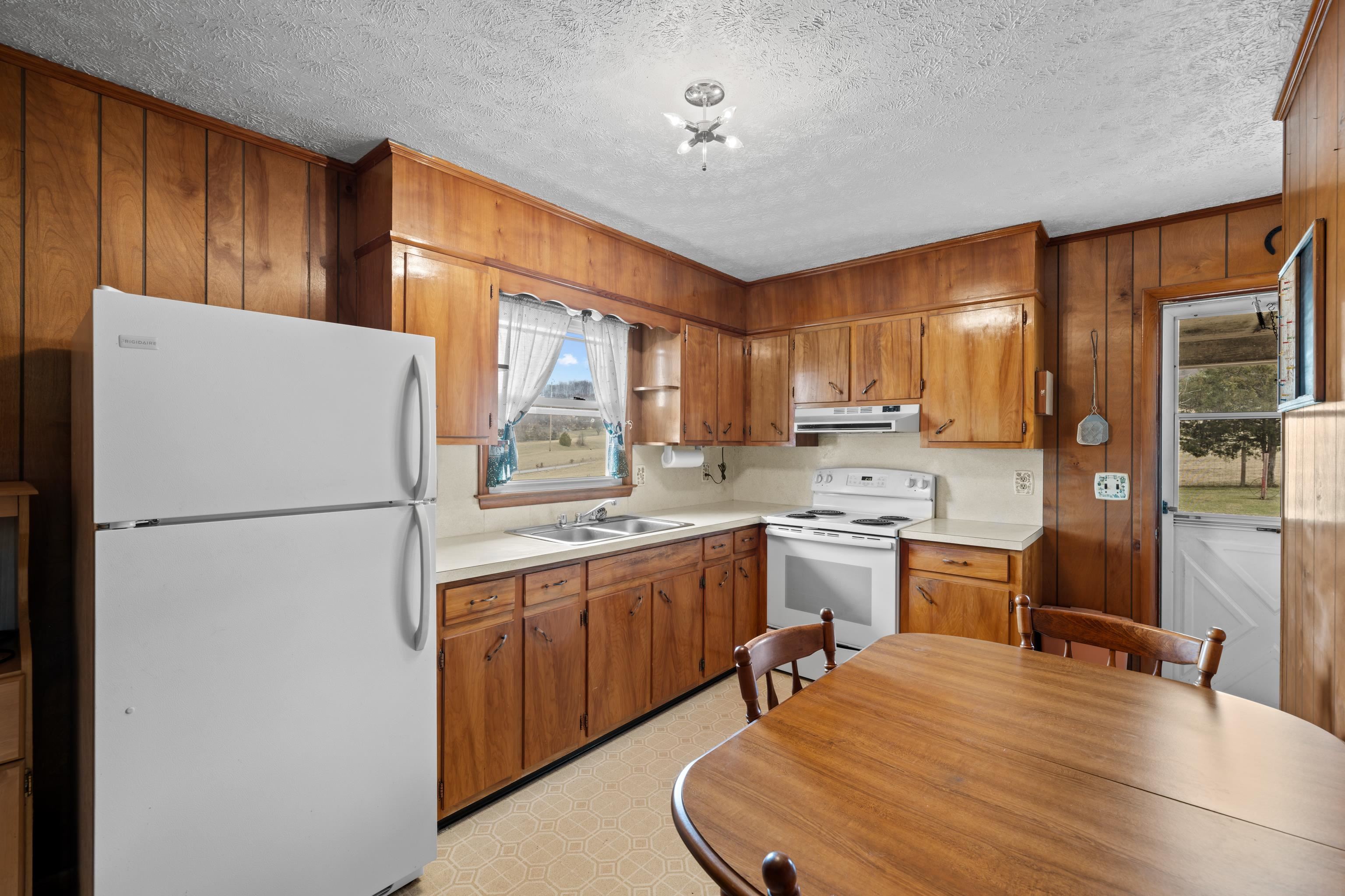 3493 Zion Church Road Broadway, VA 22815 - Photo 12 of 74 a kitchen with a refrigerator a stove top oven a sink dishwasher and wooden cabinets with wooden floor