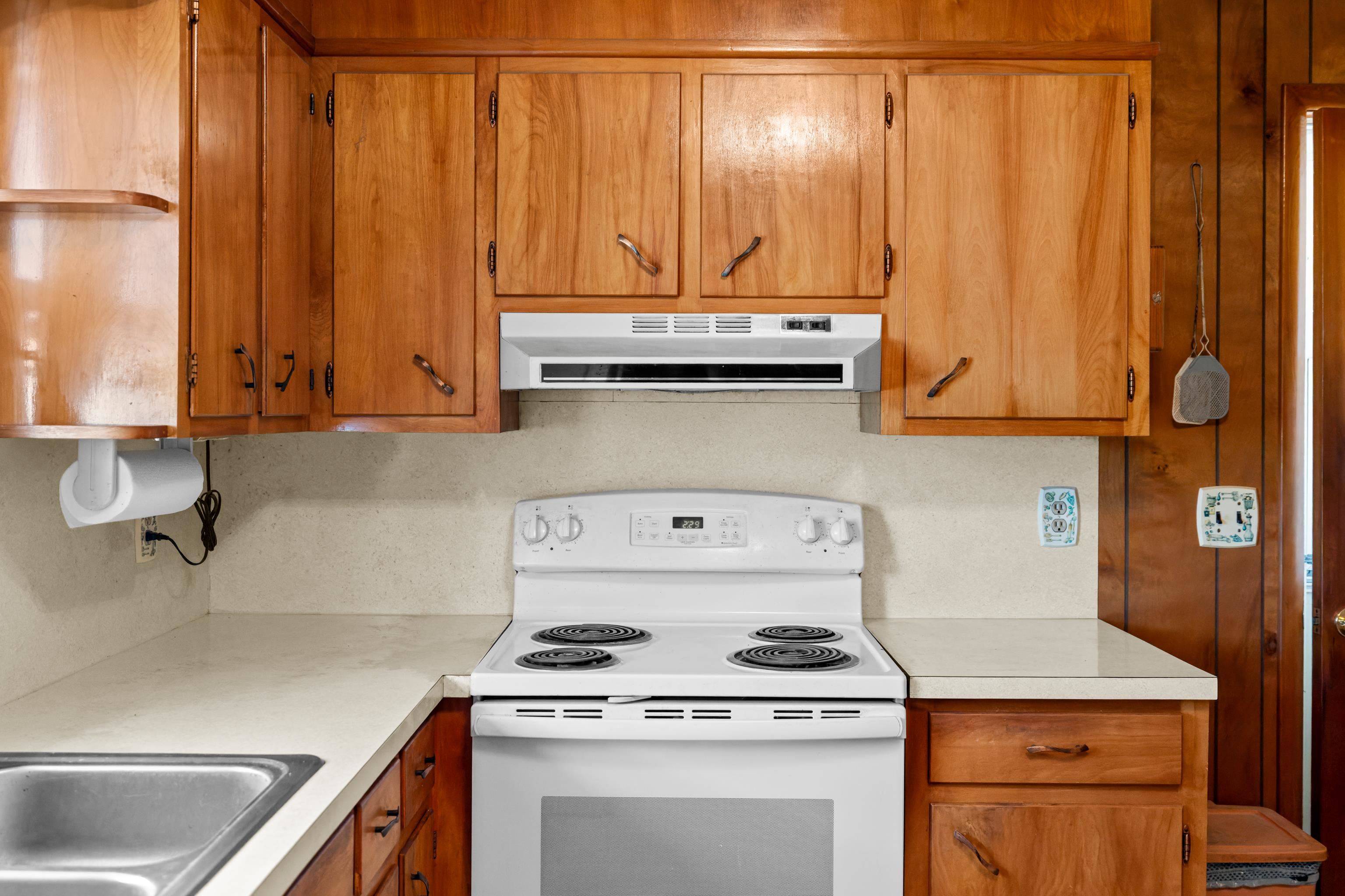 3493 Zion Church Road Broadway, VA 22815 - Photo 16 of 74 a kitchen with granite countertop a sink a stove and a microwave