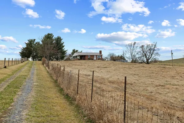 a view of a yard with wooden fence