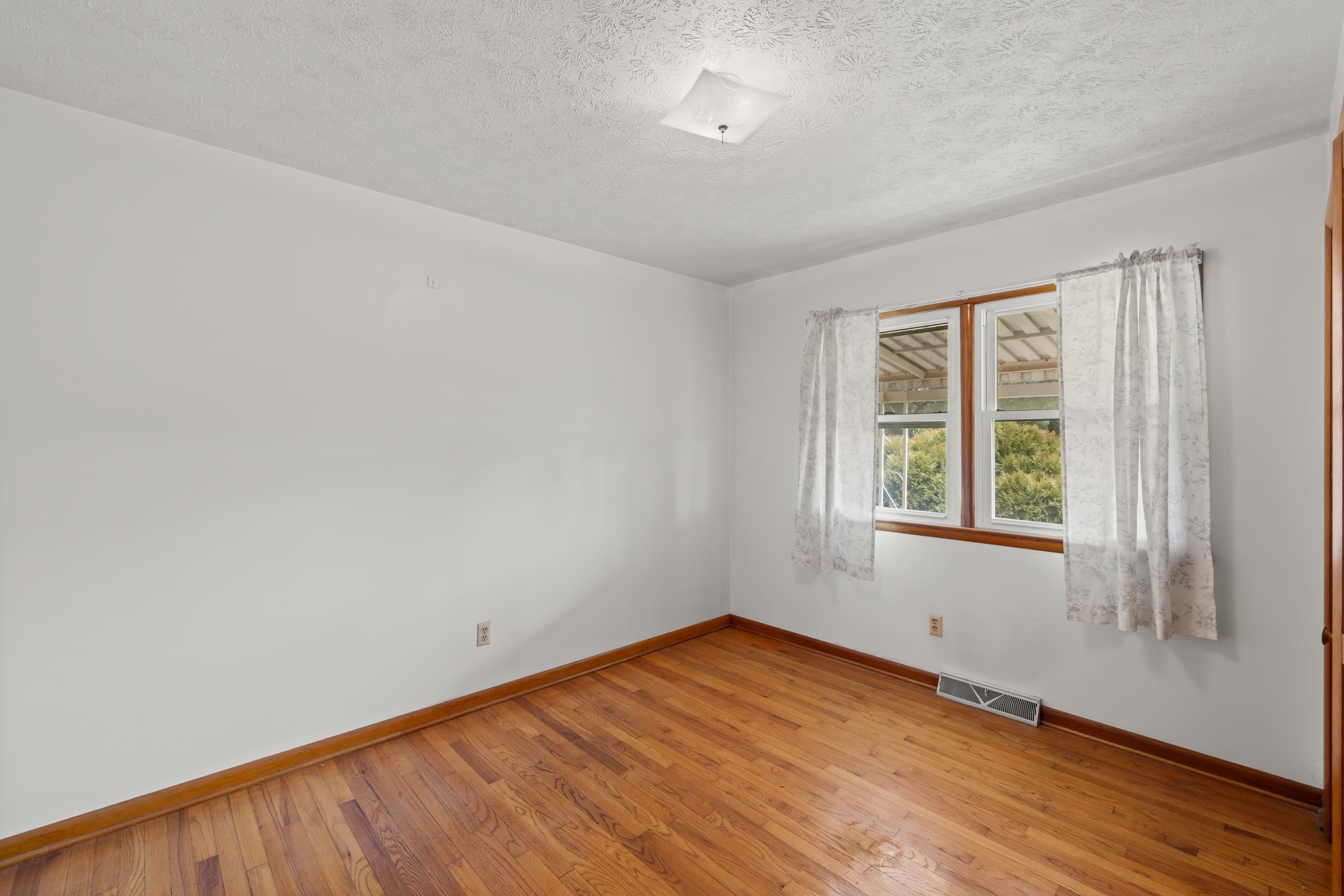 3493 Zion Church Road Broadway, VA 22815 - Photo 26 of 74 an empty room with wooden floor and windows