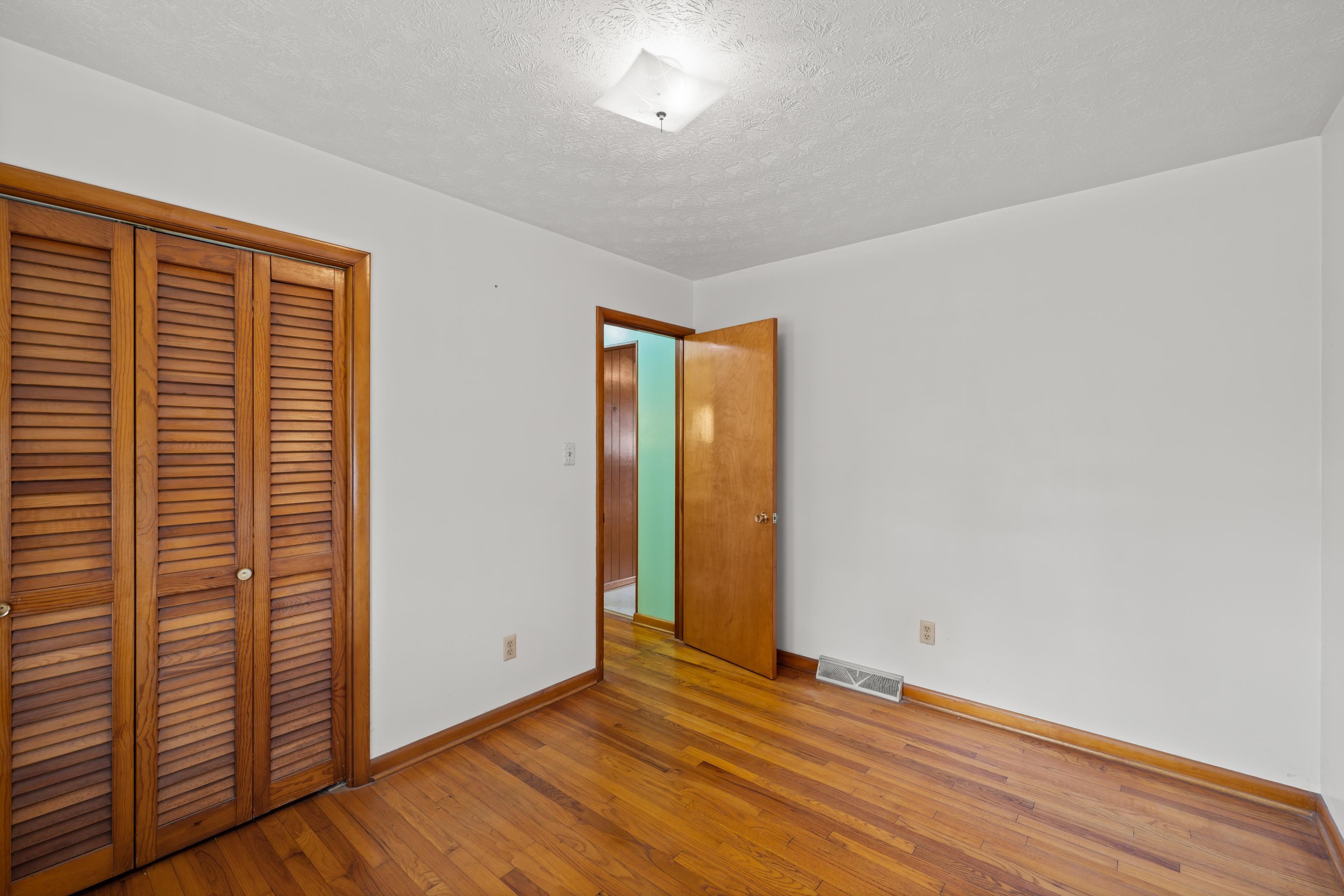 3493 Zion Church Road Broadway, VA 22815 - Photo 27 of 74 a view of an empty room with wooden floor and a window