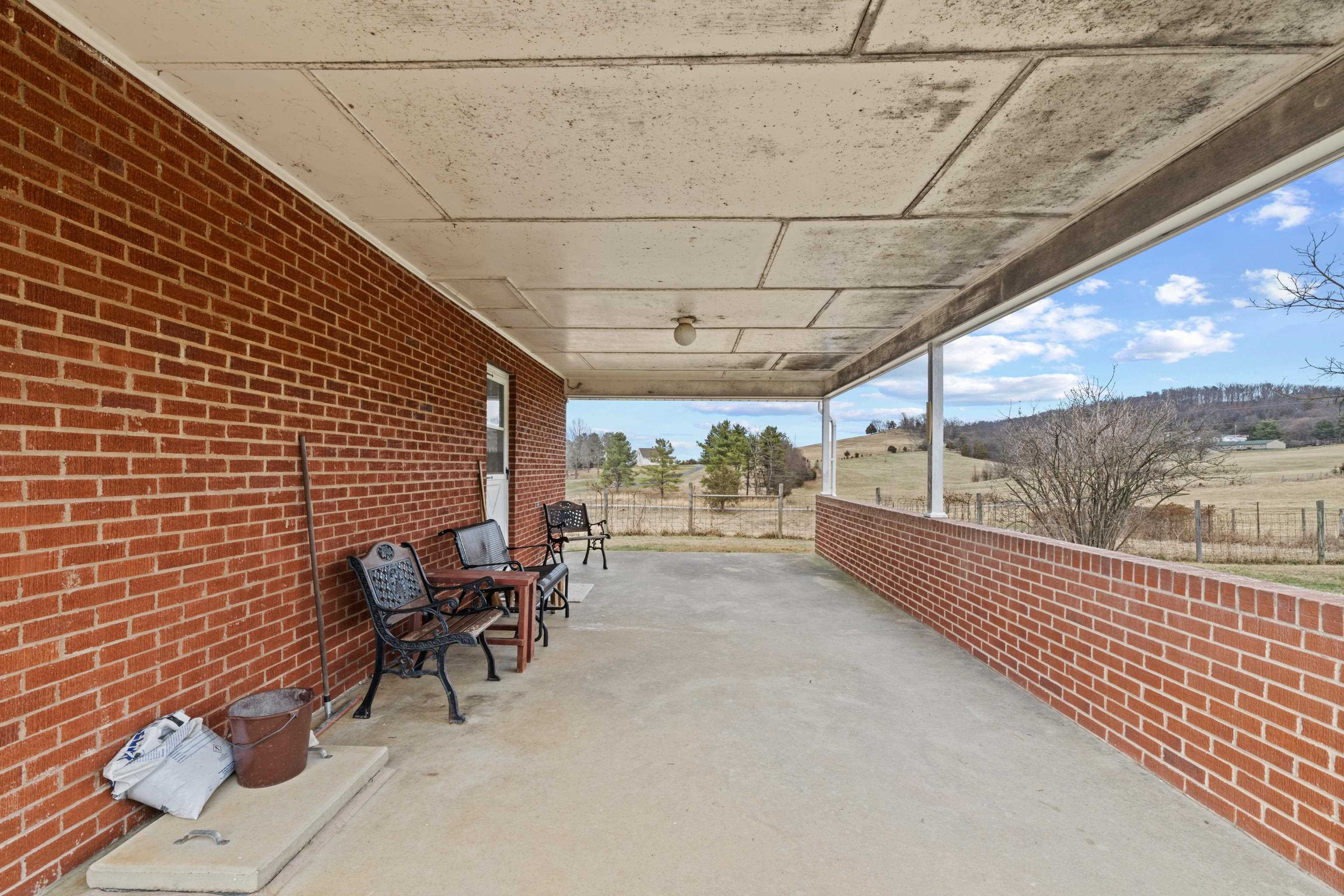 3493 Zion Church Road Broadway, VA 22815 - Photo 32 of 74 a view of a patio with table and chairs and wooden floor