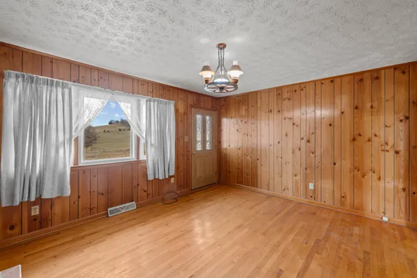 a kitchen with stainless steel appliances granite countertop a refrigerator a stove top oven a sink dishwasher and wooden cabinets with wooden floor