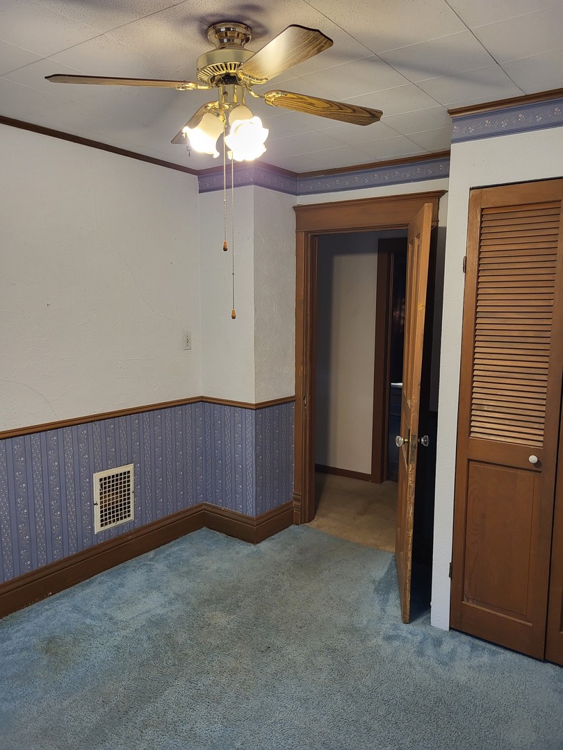 102 South 9th Street Rochelle, IL 61068 - Photo 11 of 13 a view of an empty room with a chandelier fan