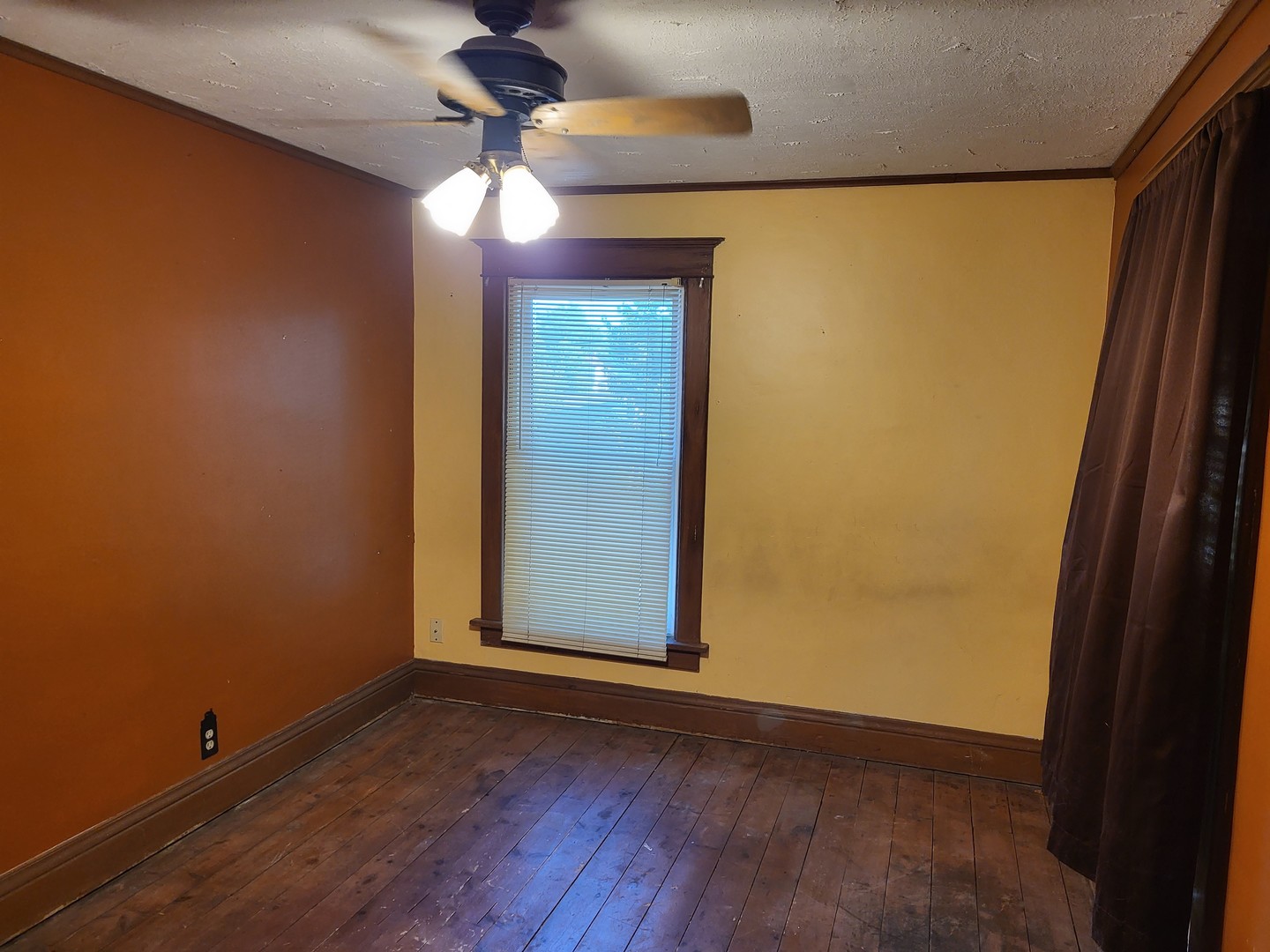 102 South 9th Street Rochelle, IL 61068 - Photo 13 of 13 a view of empty room with wooden floor and fan