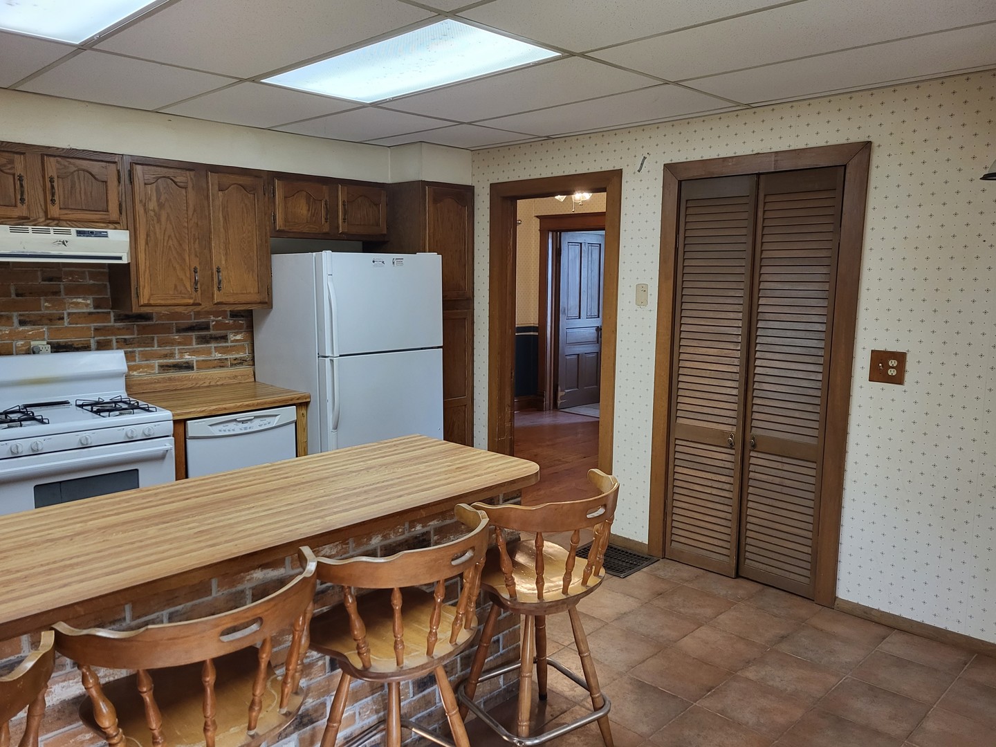 102 South 9th Street Rochelle, IL 61068 - Photo 3 of 13 a kitchen with a table chairs refrigerator and microwave