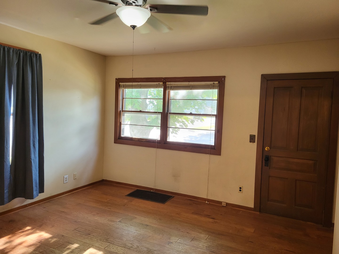 102 South 9th Street Rochelle, IL 61068 - Photo 6 of 13 an empty room with windows and fan