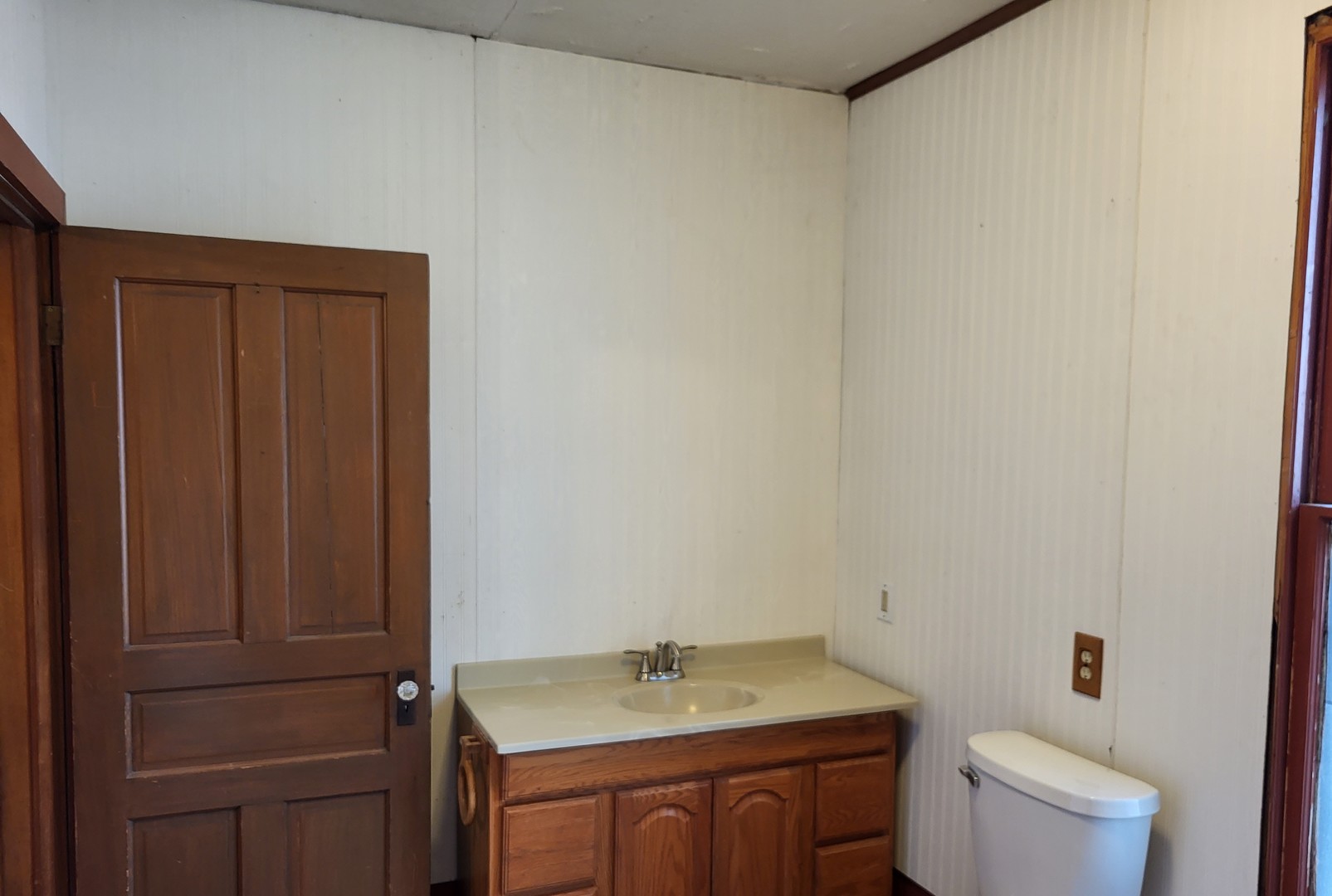 102 South 9th Street Rochelle, IL 61068 - Photo 9 of 13 a bathroom with a sink a toilet and vanity