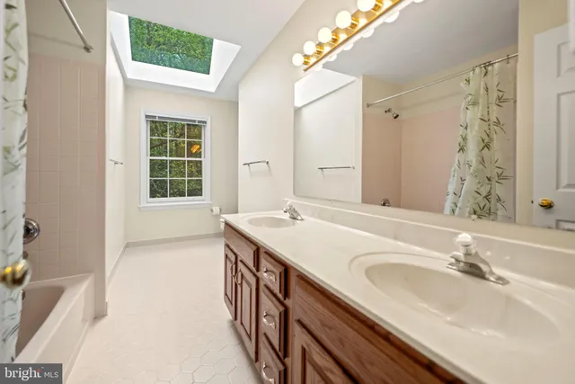 a bathroom with a sink double vanity and a mirror