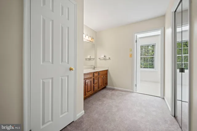 a spacious bathroom with a double vanity sink and a mirror