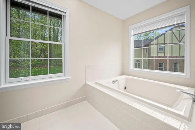 a white bath tub sitting next to a window