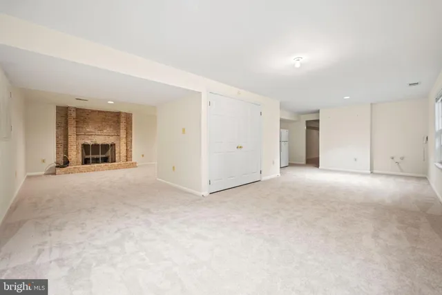 a view of an empty room with a kitchen