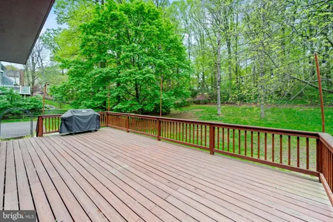 a view of balcony with deck and yard
