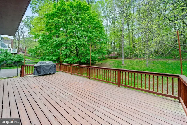 a view of balcony with deck and yard